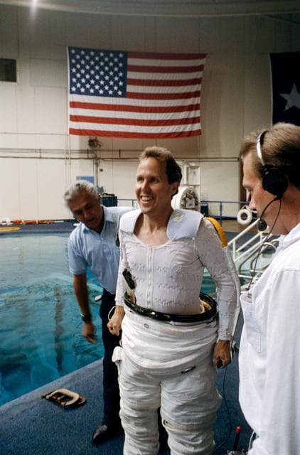 NASA image: Astronaut Jones donning EMU during space walk simulations for STS-59