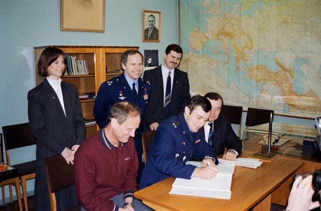 NASA image: Astronauts & cosmonauts sign Gagarin's diary