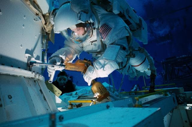 NASA image: Astronauts Tamara Jernigan and Daniel Barry train in the NBL for STS-96