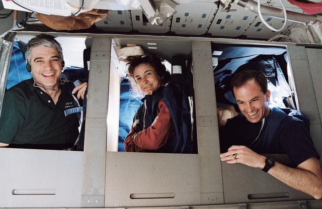 NASA image: STS-59 crewmembers pictured in bunks on the middeck