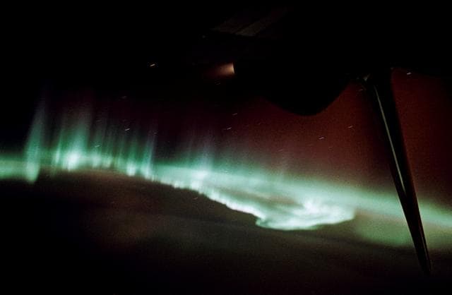NASA image: Endeavour and its SRL-1 payload backdropped against the Southern Lights