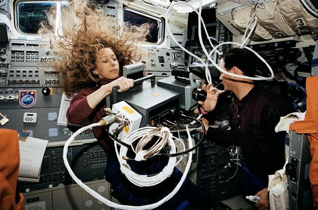 NASA image: Astronaut Marsha Ivins with thermal imaging project on flight deck