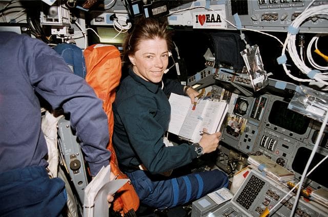 NASA image: Dunbar reviews checklist on forward flight deck