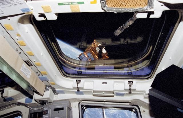 NASA image: OAST-Flyer is deployed by the Remote Manipulator System (RMS) as viewed from the flight deck