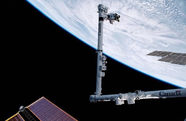 NASA image: View of the SSRMS against an Earth limb during STS-100