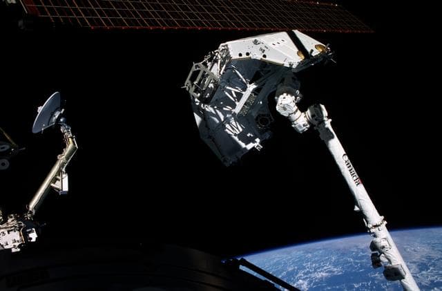 NASA image: View of the SSRMS grappling the Spacelab Pallet during STS-100