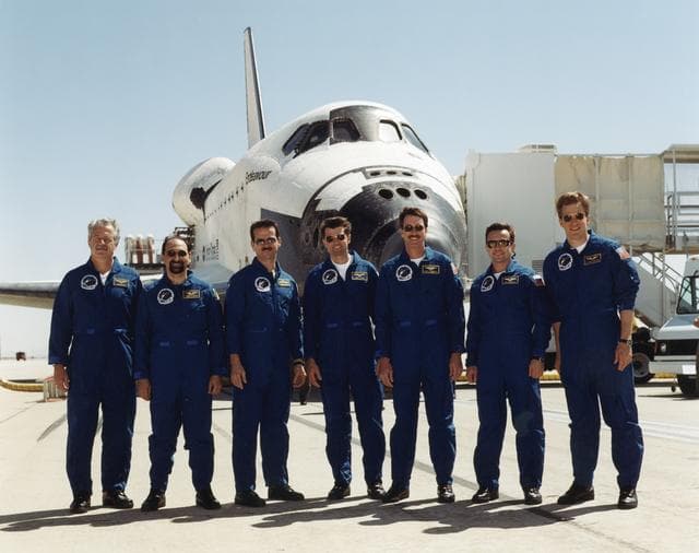 The STS-100 crew pose in front of Endeavour after landing at Edwards AFB