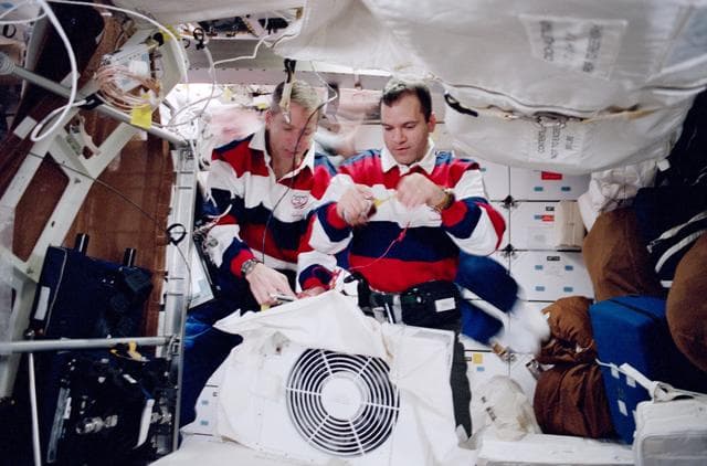 NASA image: Richards performs IFM on Cabin Air Cleaner Assembly