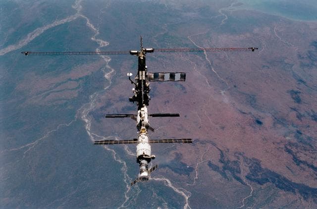 NASA image: View of the ISS during flyaround backdropped by the Earth