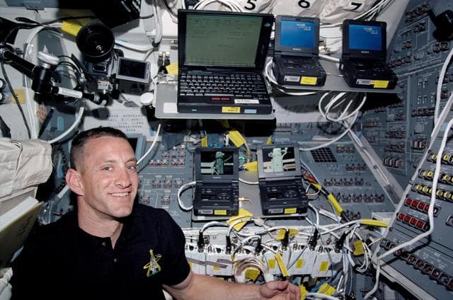 NASA image: STS-104 PLT Hobaugh and DV Cam units on Atlantis flight deck