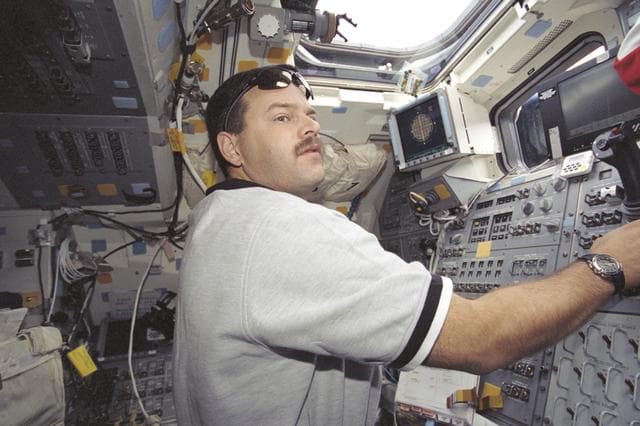 NASA image: Pilot Altman at the aft crew workstation during STS-106 undocking with ISS