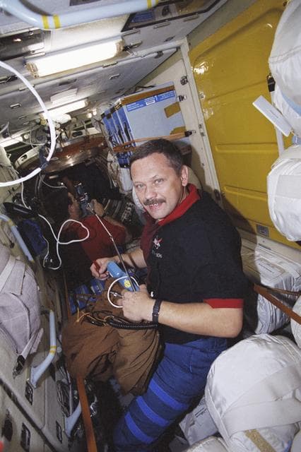 NASA image: Morukov and Altman among stowage bags in Zarya taken during STS-106
