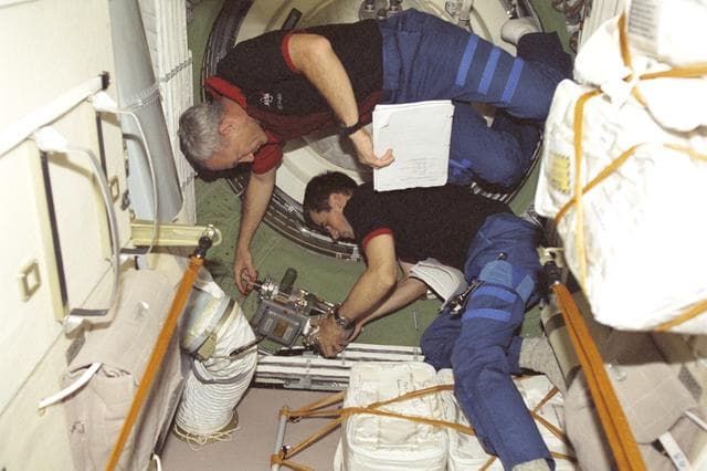 NASA image: Wilcutt and Malenchenko perform egress procedures in Zarya during STS-106