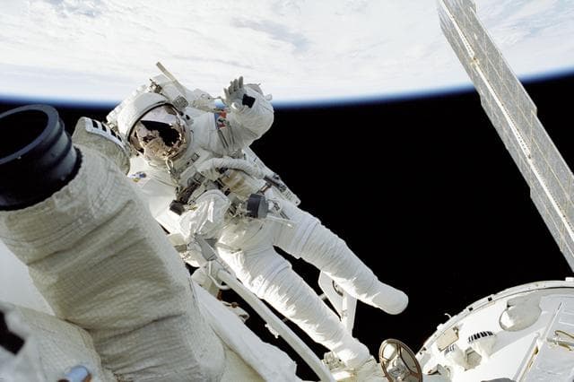 NASA image: MS Malenchenko waves while working on Zvezda during STS-106's EVA