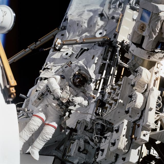 NASA image: EVA 4 - MS Wolf works with Interface Umbilical Assembly on MT