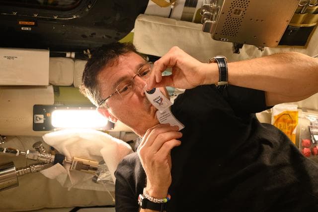 NASA image: Reid Wiseman Collects Saliva Sample Aboard Orion