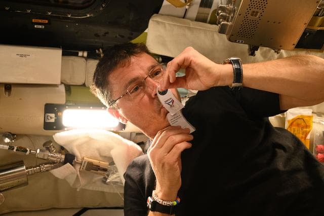 NASA image: Reid Wiseman Collects Saliva Sample Aboard Orion