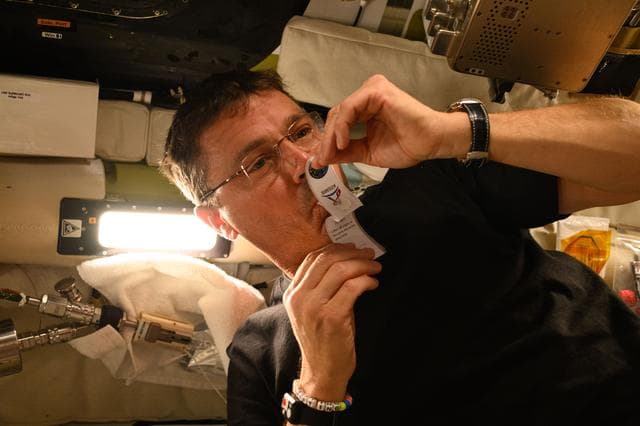 NASA image: Reid Wiseman Collects Saliva Sample Aboard Orion
