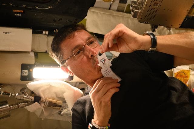 NASA image: Reid Wiseman Collects Saliva Sample Aboard Orion