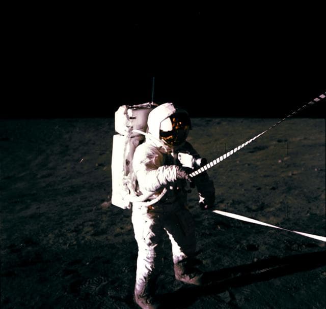 NASA image: Astronaut Charles Conrad uses lunar equipment conveyer at Lunar Module