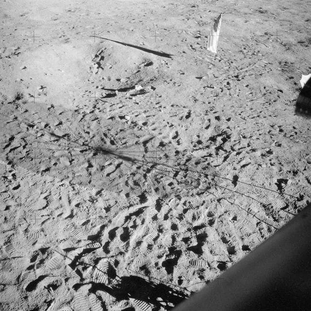 NASA image: Apollo 12 Mission image - View of footprints and the flag pole as taken from the Lunar Module (LM) 
