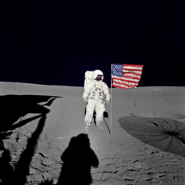 NASA image: Apollo 14 Mission image - Astronaut Edgar D. Mitchell, lunar module pilot for the Apollo 14 lunar landing mission, stands by the deployed U.S. flag on the lunar surface during the early moments of the first extravehicular activity (EVA-1) of the mission. 