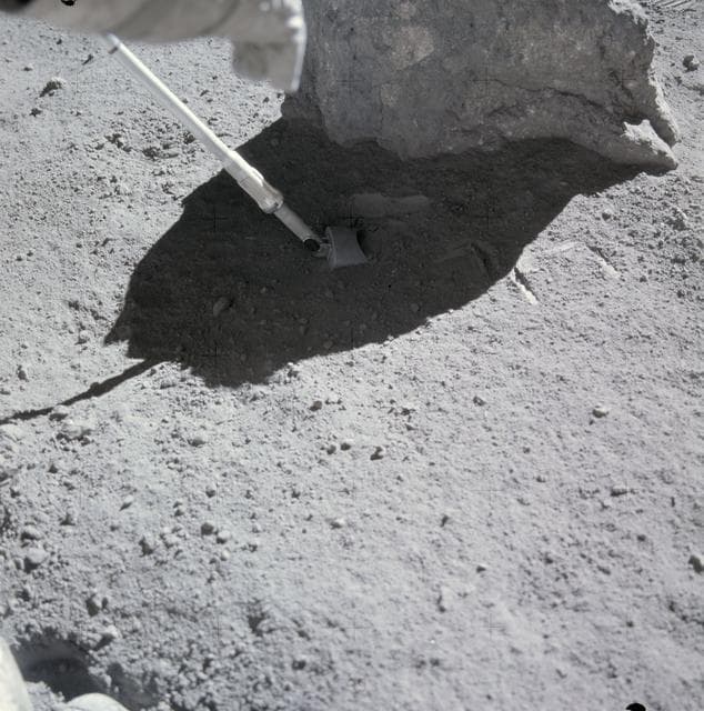 NASA image: Apollo 16 astronauts take lunar soil sample from Station no.9 during EVA