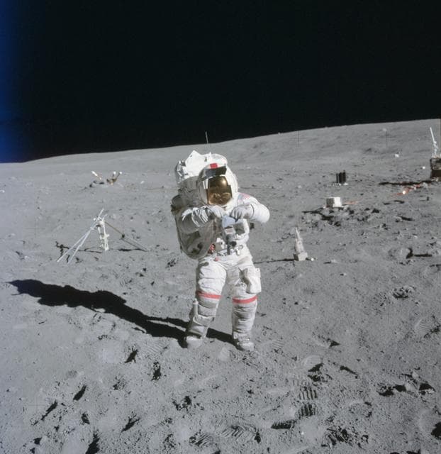 Astronaut John Young stands at ALSEP deployment site during first EVA