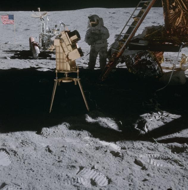NASA image: Astronaut John Young in shadow of Lunar Module behind ultraviolet camera