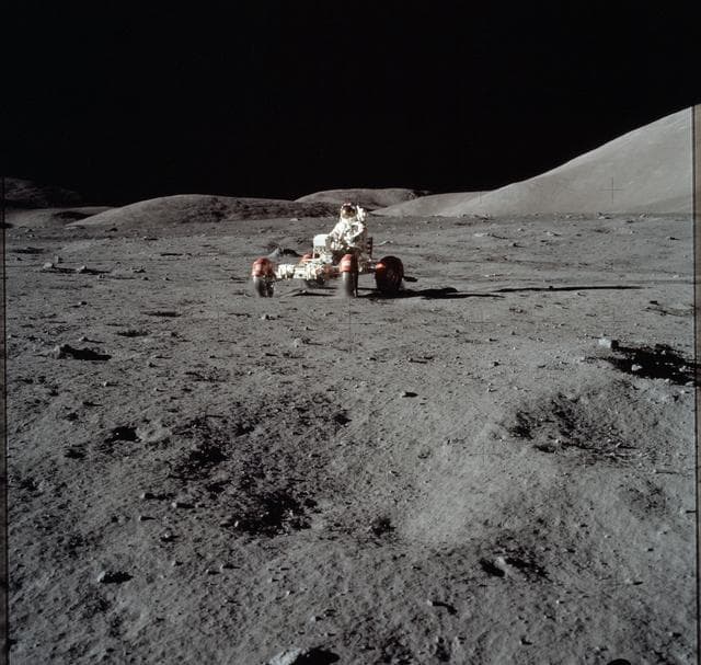 Astronaut Eugene Cernan drives the Lunar Roving Vehicle during first EVA