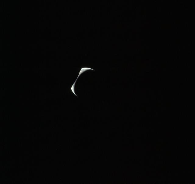 NASA image: Cresent Earth eclipsed by silhouetted horizon of the moon