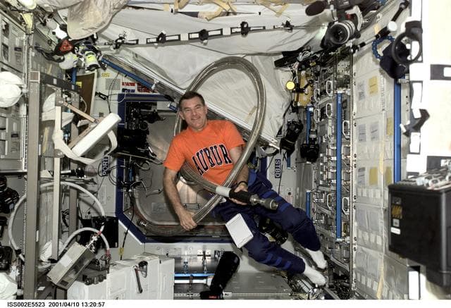 NASA image: Voss jokes with long hose in Destiny Laboratory module