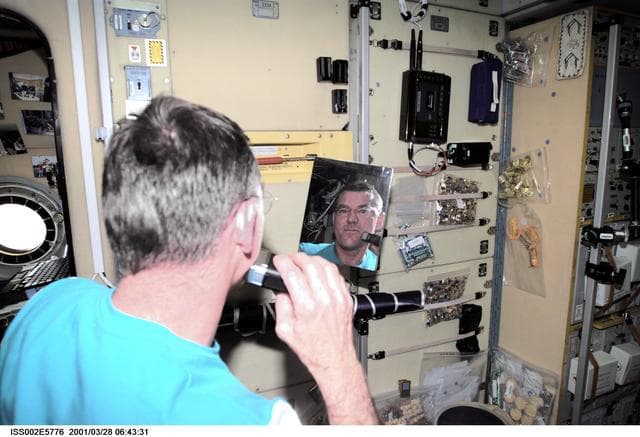 NASA image: Voss shaves in Service Module