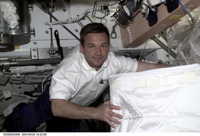 Lonchakov moving stowage bags in ISS