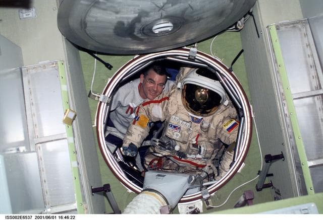 NASA image: Voss moves Orlan suit in forward hatch of Zvezda module