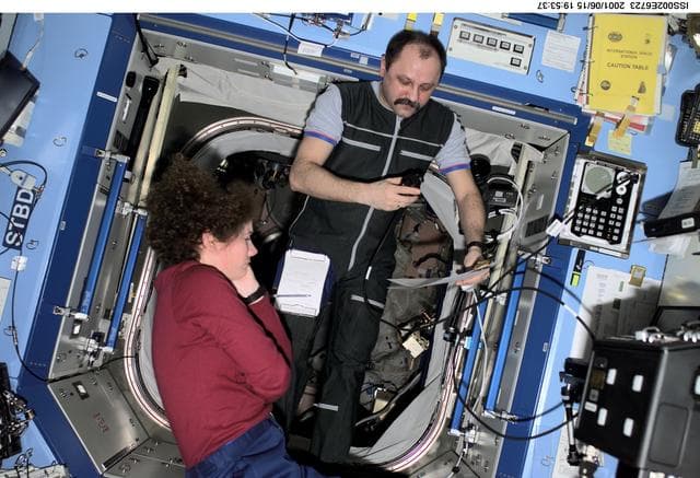NASA image: Helms and Usachev with checklist in Destiny laboratory module