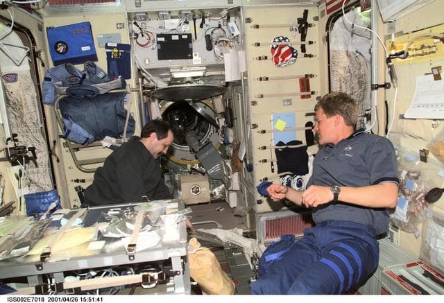 NASA image: STS-100 MS Parazynski in conversation with Usachev in Service Module