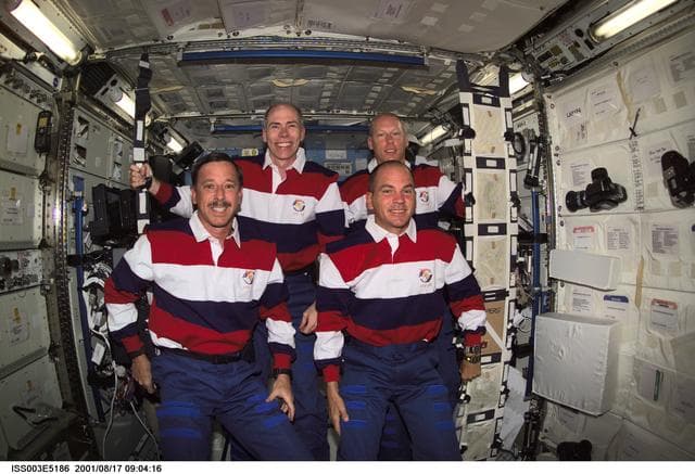 NASA image: STS-105 crewmembers pose for their group photo in the U.S. Laboratory