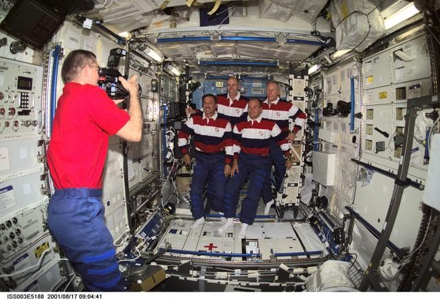 NASA image: Voss videotapes the STS-105 crewmembers in the U.S. Laboratory