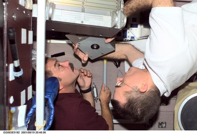 NASA image: Tyurin and Voss perform maintenance on the TVIS treadmill in the Service Module