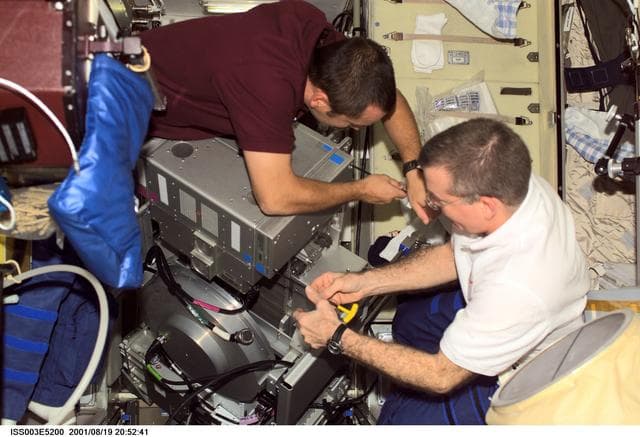 NASA image: Tyurin and Voss perform maintenance on the TVIS treadmill in the Service Module
