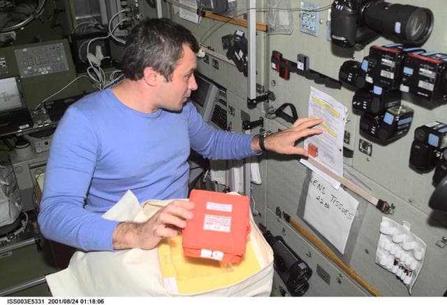 NASA image: Flight Engineer Dezhurov unpacks a bag in the Service Module during Expedition Three