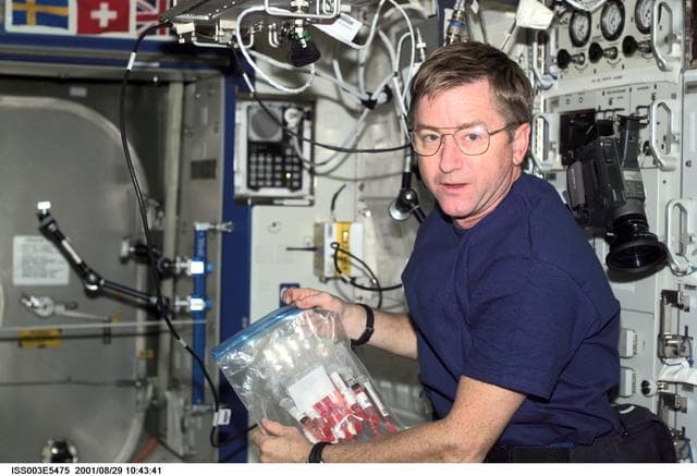 NASA image: Culbertson holds a syringe kit in Destiny during Expedition Three