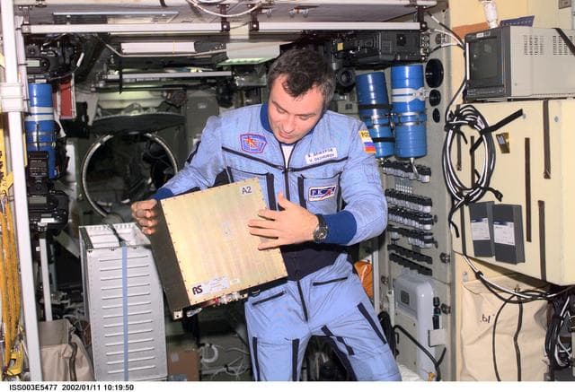 NASA image: Dezhurov holds a GTS electronics unit in Zvezda during Expedition Three