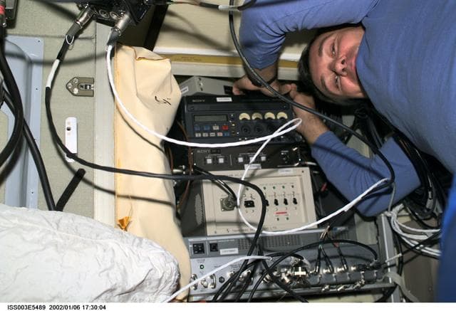 NASA image: Dezhurov works with electronic equipment in Zvezda during Expedition Three