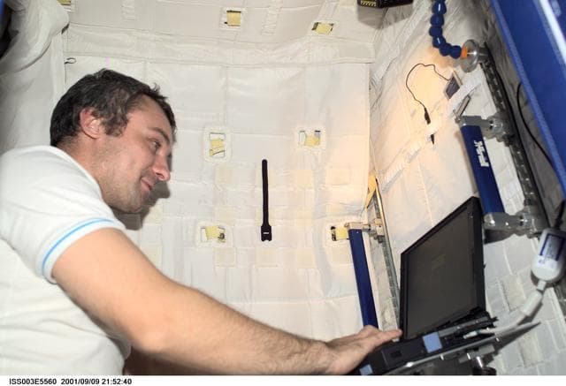 NASA image: Dezhurov works in the sleep station in the U.S. Laboratory during Expedition Three