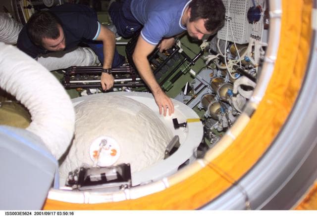 NASA image: Dezhurov and Tyurin remove the docking probe in Zvezda during Expedition Three