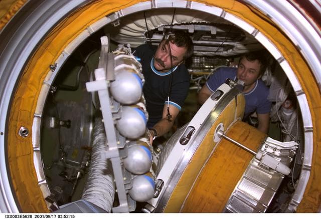 NASA image: Dezhurov and Tyurin remove the docking probe in Zvezda during Expedition Three