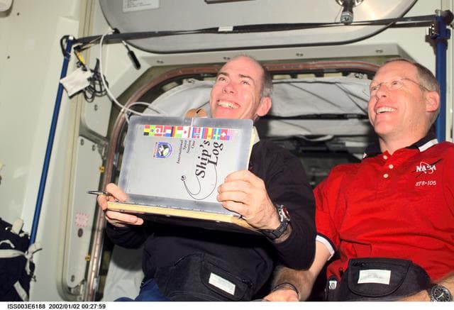 NASA image: Barry and Forrester with the ISS logbook in Node 1
