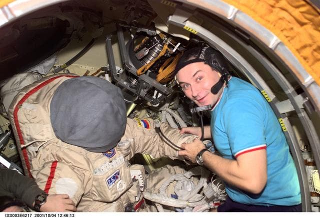 NASA image: Dezhurov works on an Orlan suit in Pirs during Expedition Three